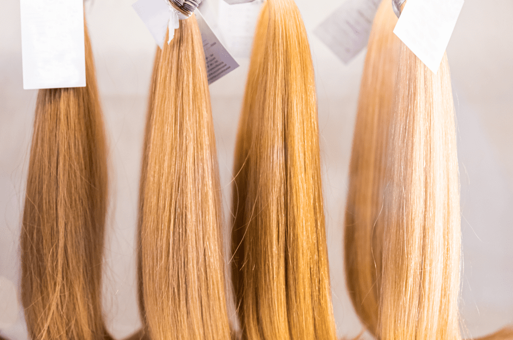 A row of hair extensions hanging on the wall.